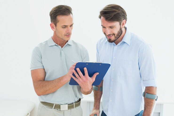 male therapist discussing reports with disabled patient 13339 29730