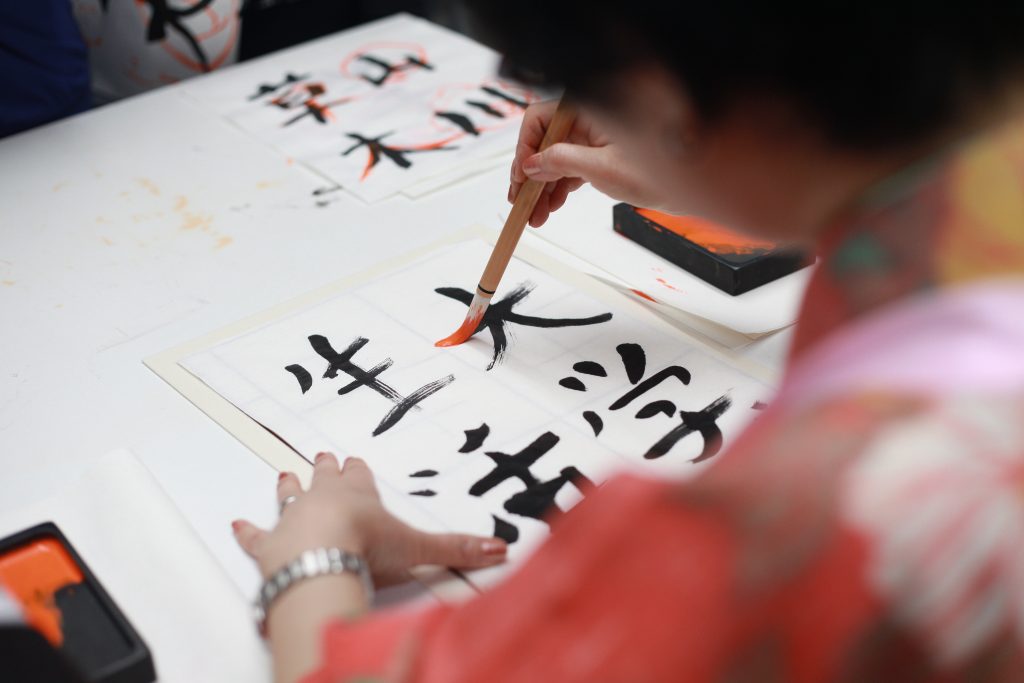 woman drawing oriental symbols 1